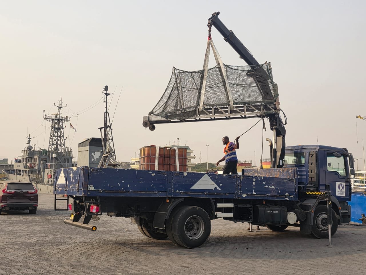 Port crane lifting cargo from a truck
